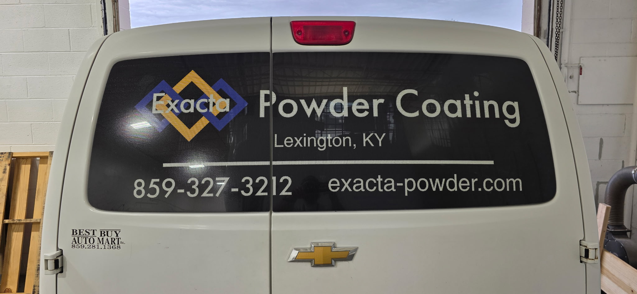 View-thru vinyl rear window graphic installed on a company vehicle for Exacta Powder Coating in Lexington, Kentucky.