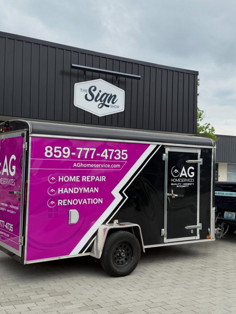 Custom trailer wrap for AG Home Services featuring bright magenta branding, contact information, and service listings including home repair, handyman, and renovation services. Trailer graphics installed in Central Kentucky by The Sign Shop.