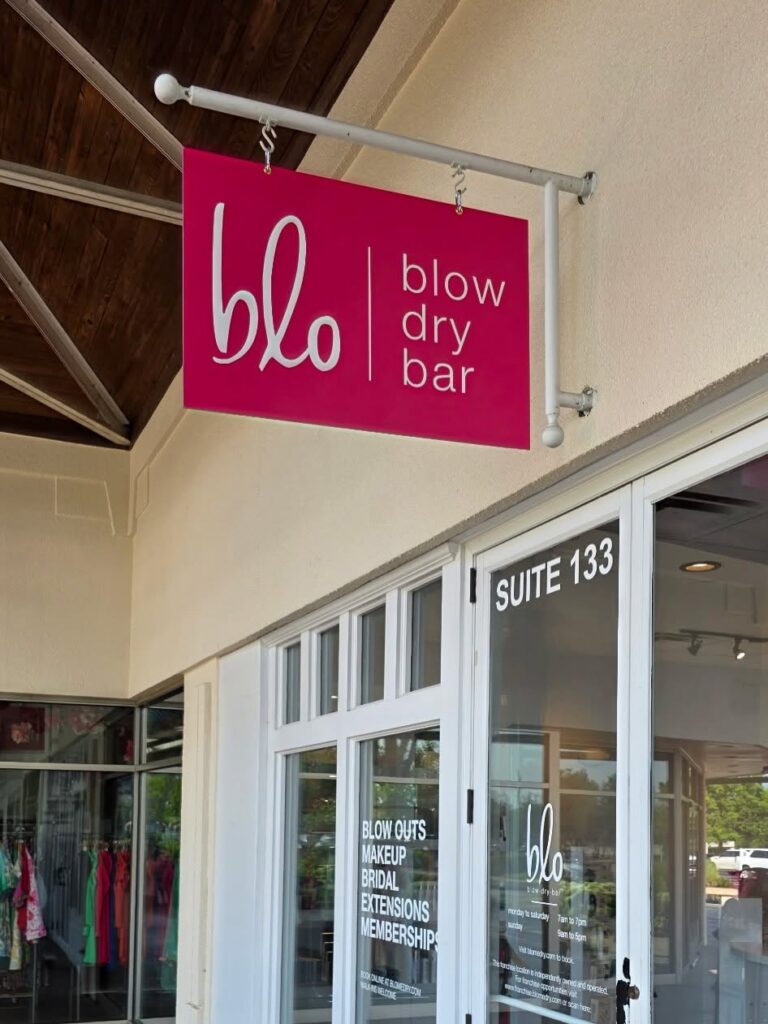 Custom hanging storefront sign installed for a Lexington Kentucky retail business.