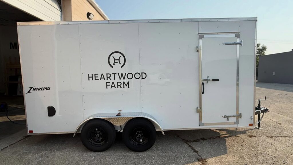 Heartwood Farm enclosed trailer with custom black vinyl logo graphics installed by The Sign Shop in Lexington, Kentucky.
