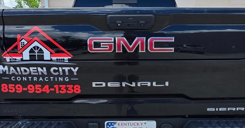 Rear tailgate graphics installed on GMC work truck.