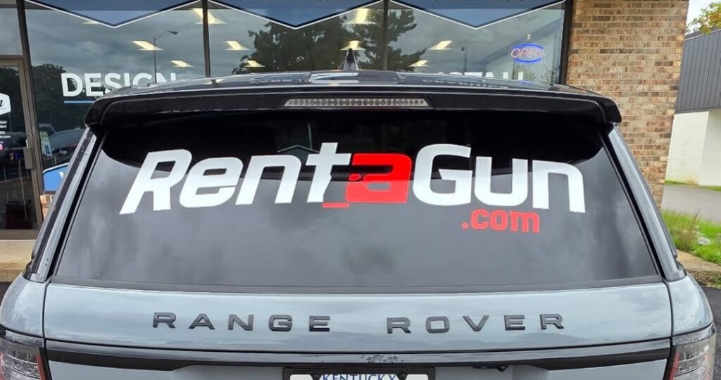 Large RentAGun.com vinyl logo graphic on rear vehicle window