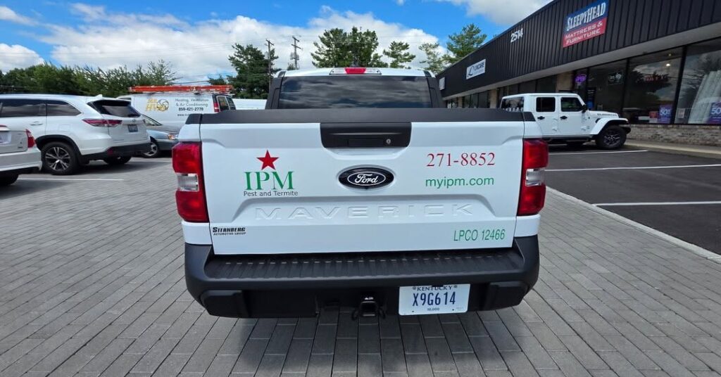 Custom tailgate logo and vinyl lettering for an IPM Pest and Termite work truck
